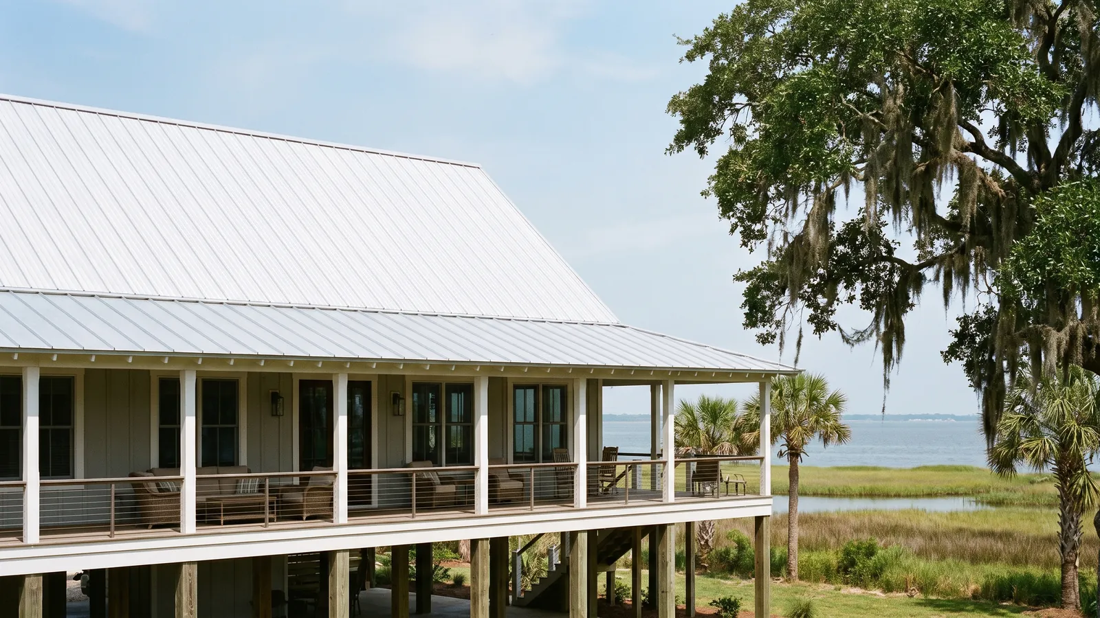 Galvalume standing-seam metal roof on a raised coastal home near Mobile Bay under a humid sky